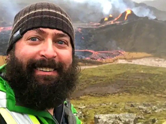 Male student selfie with volcanoes in Iceland in the background